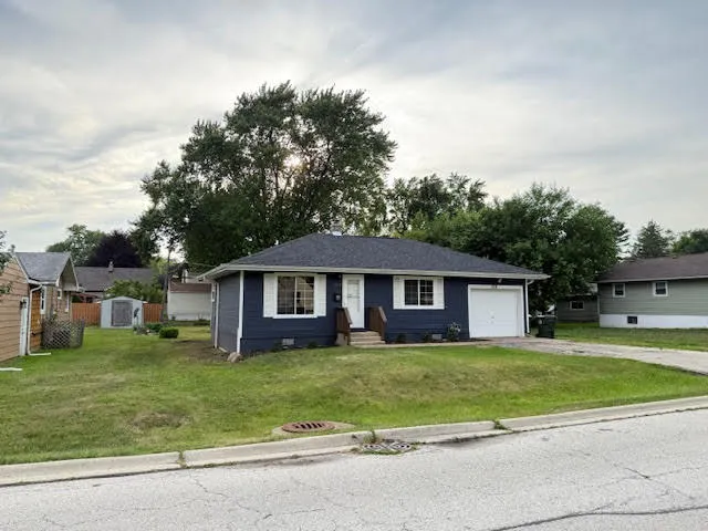 a view of a house with a big yard and large trees