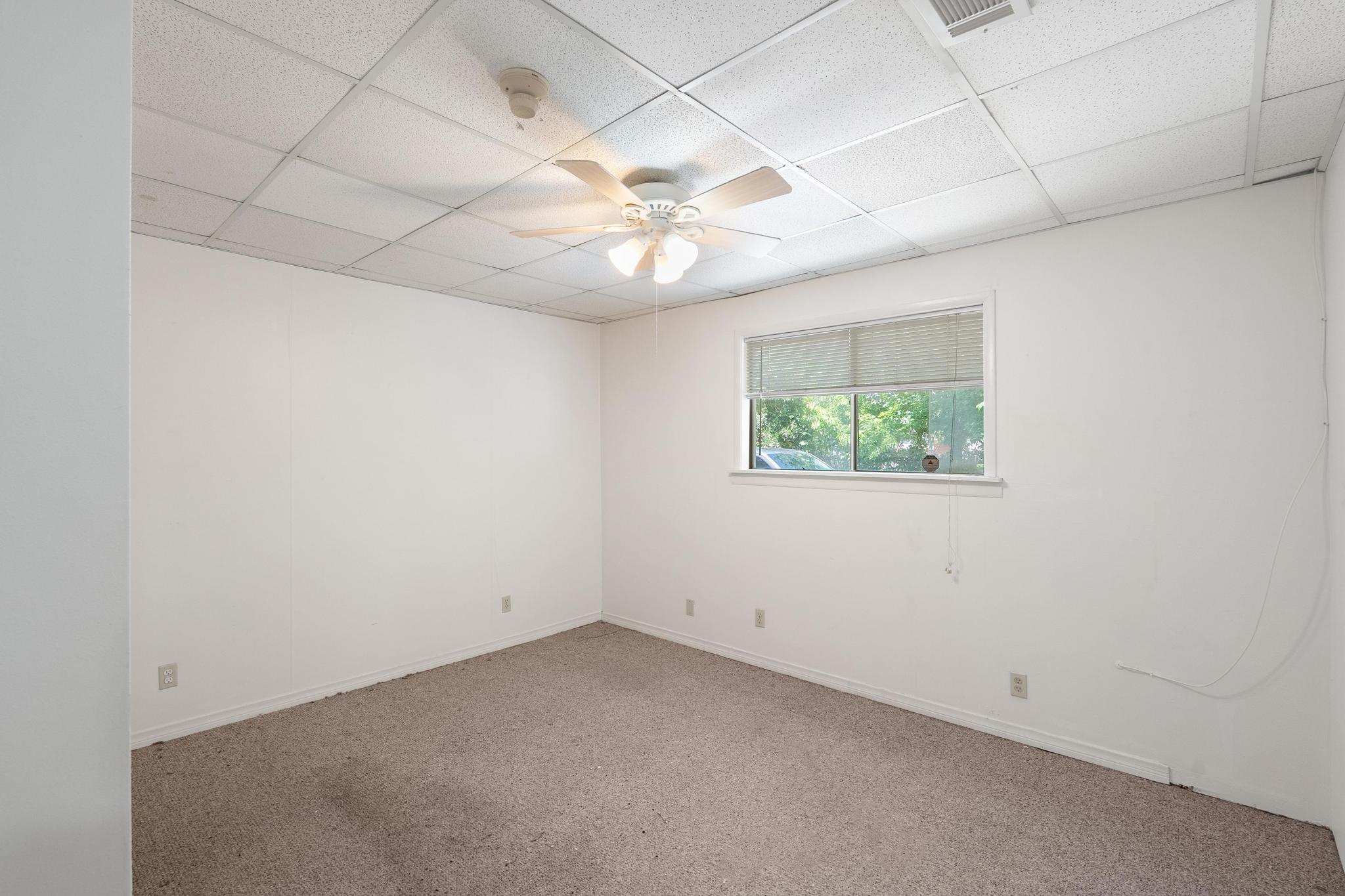 4616 East Cesar Chavez Street Austin, TX 78702 - Photo 18 of 22 an empty room with a window and a ceiling fan