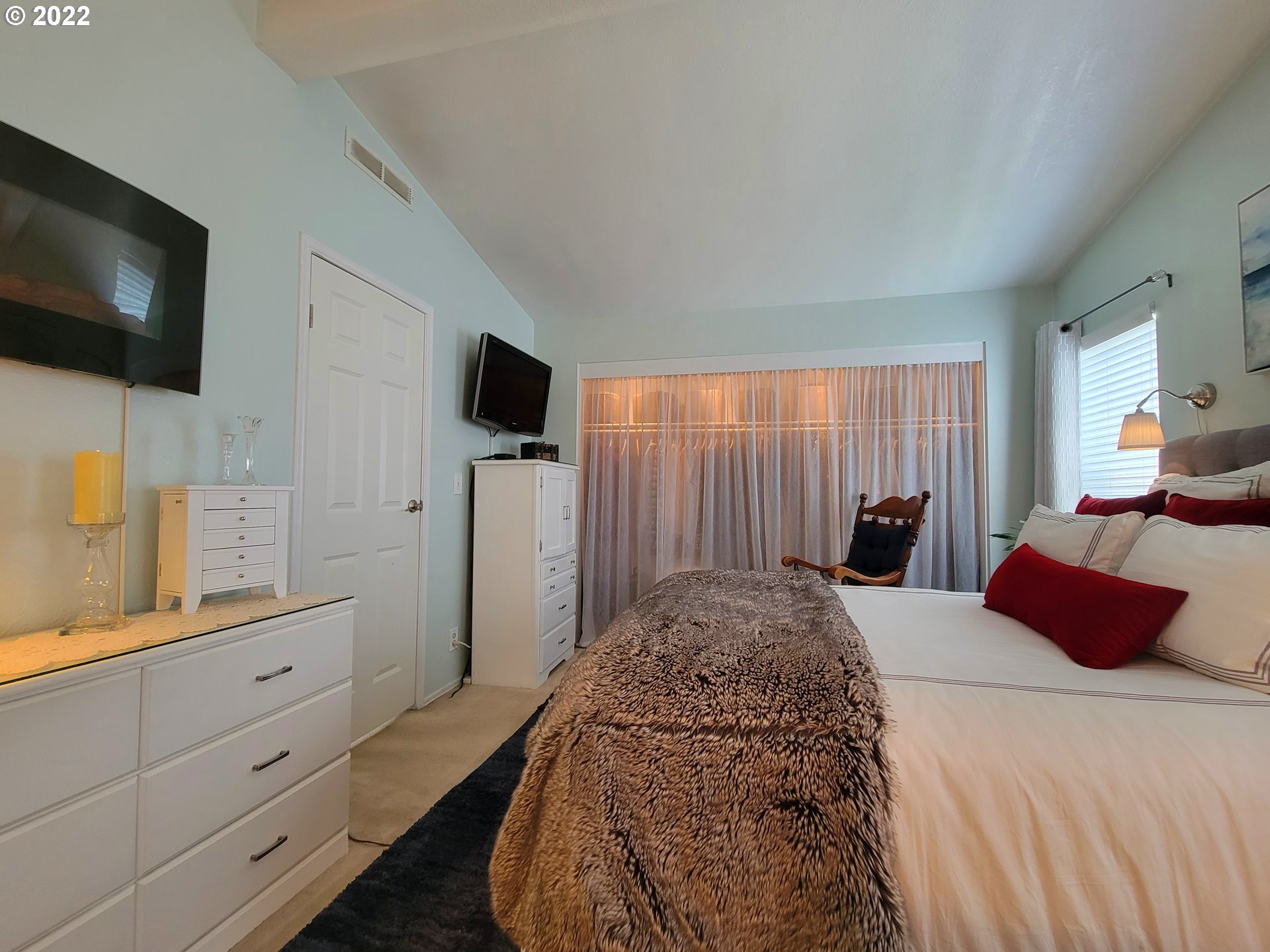 9811 Southwest Herman Road, Unit 43 Tualatin, OR 97062 - Photo 17 of 32 a bedroom with a bed a tv and wooden floor