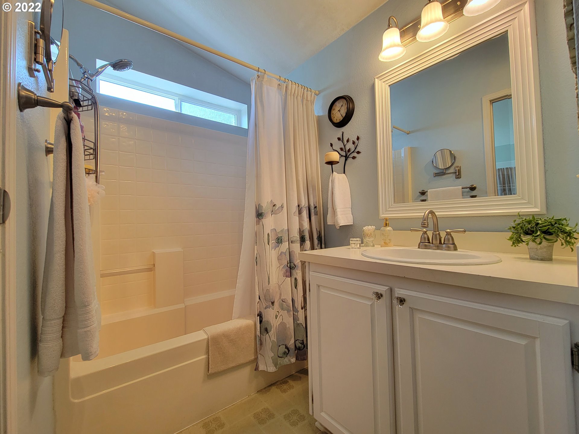 9811 Southwest Herman Road, Unit 43 Tualatin, OR 97062 - Photo 18 of 32 a bathroom with a shower sink vanity and mirror