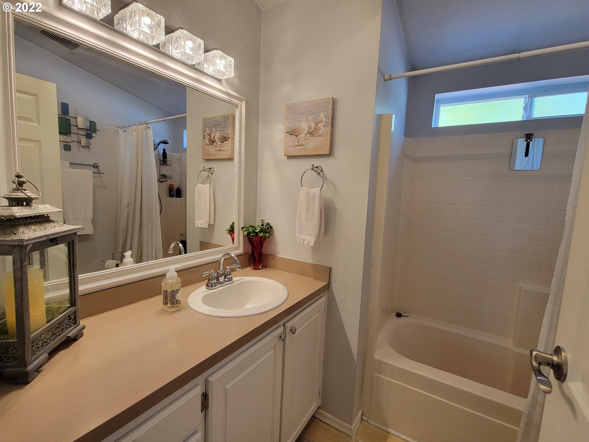 9811 Southwest Herman Road, Unit 43 Tualatin, OR 97062 - Photo 25 of 32 a bathroom with a sink a tub and a mirror