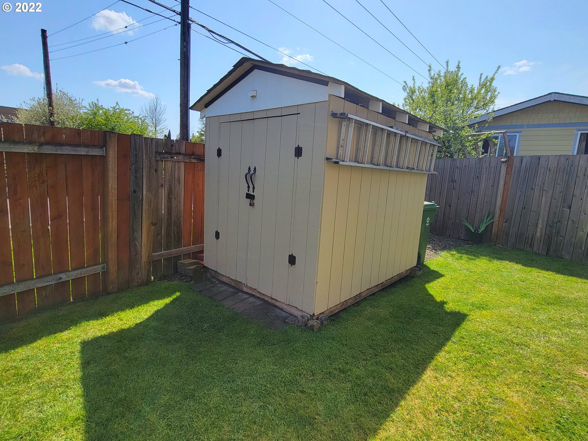 9811 Southwest Herman Road, Unit 43 Tualatin, OR 97062 - Photo 6 of 32 a view of backyard with small cabin and wooden fence