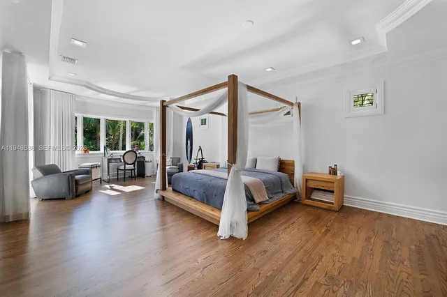 a bedroom with a bed and glass window