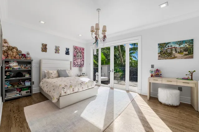 a spacious bedroom with a large bed and a chandelier