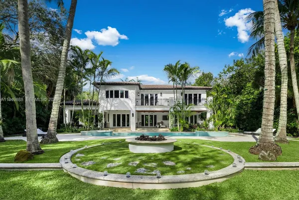 a view of a house with swimming pool and sitting area