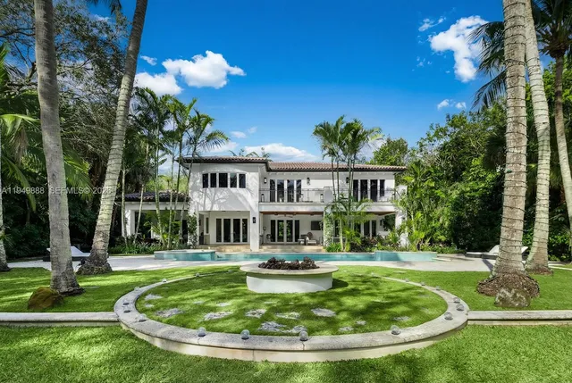 a view of a house with swimming pool and sitting area