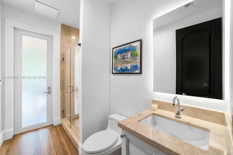 a bathroom with a granite countertop sink toilet and shower