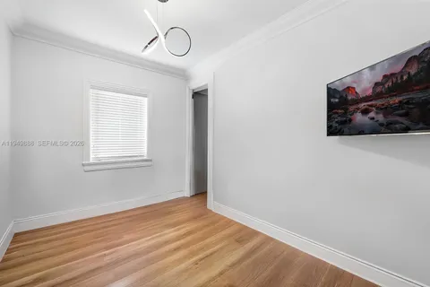a view of a room with wooden floor and white walls