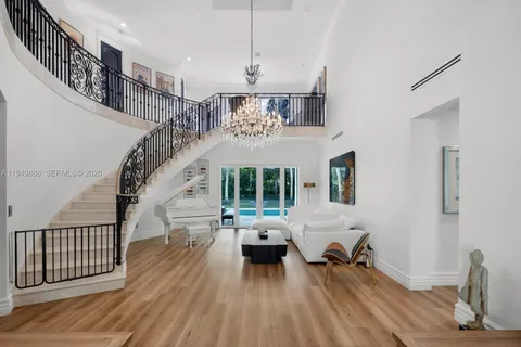 a living room with furniture floor to ceiling window and wooden floor