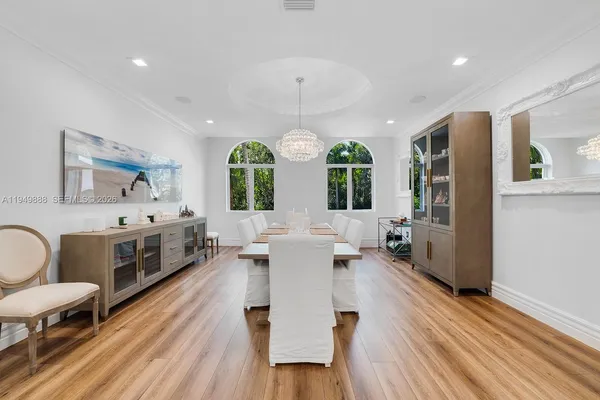 a large white kitchen with a large window