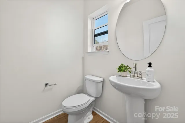 a bathroom with a sink toilet and a mirror