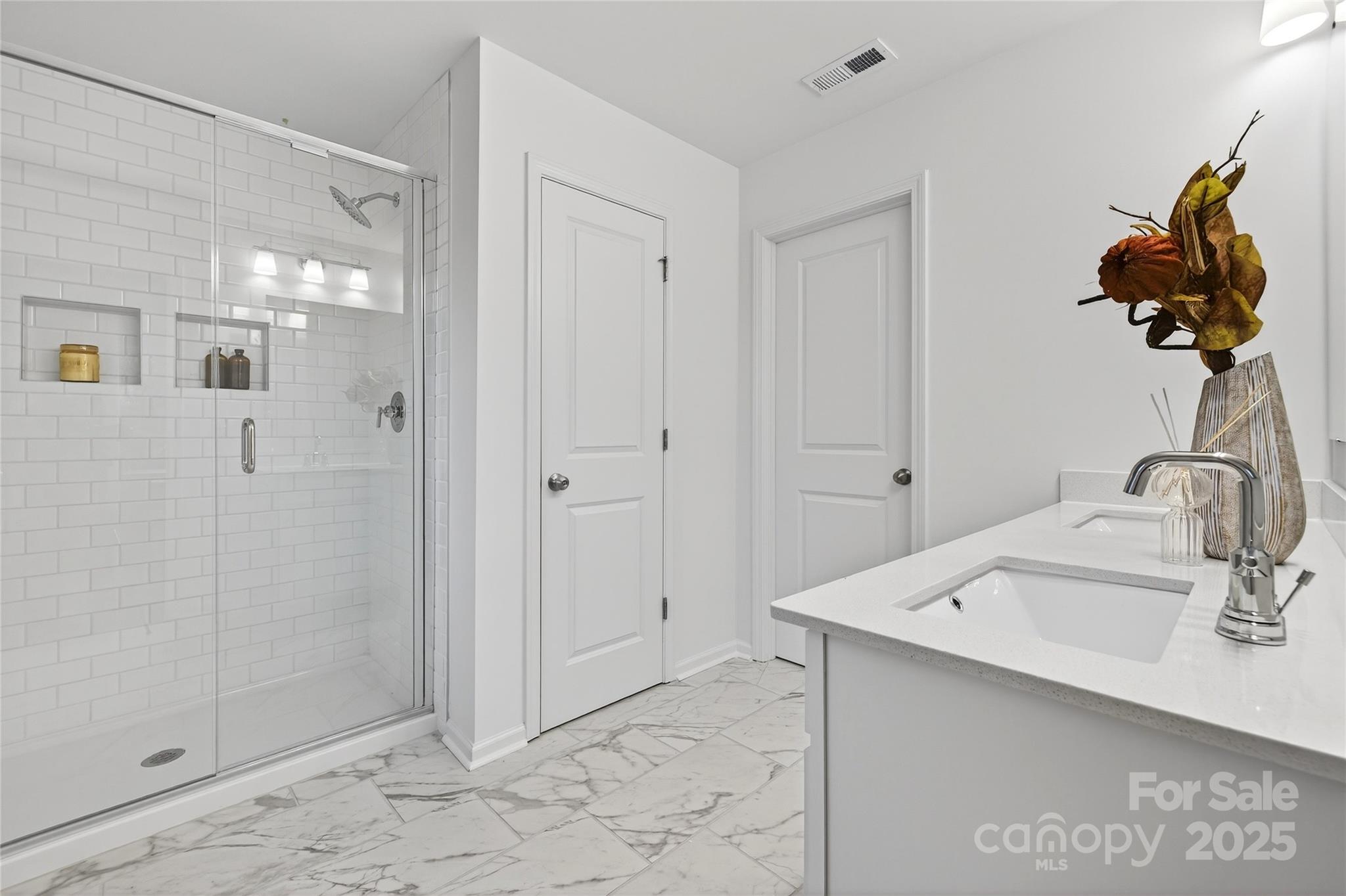 10315 Lakeshore Drive, Unit 89 Lancaster, SC 29720 - Photo 20 of 43 a bathroom with a sink mirror and shower