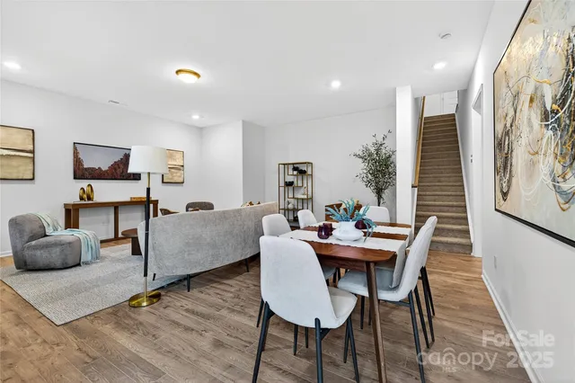 a dining room with furniture and wooden floor