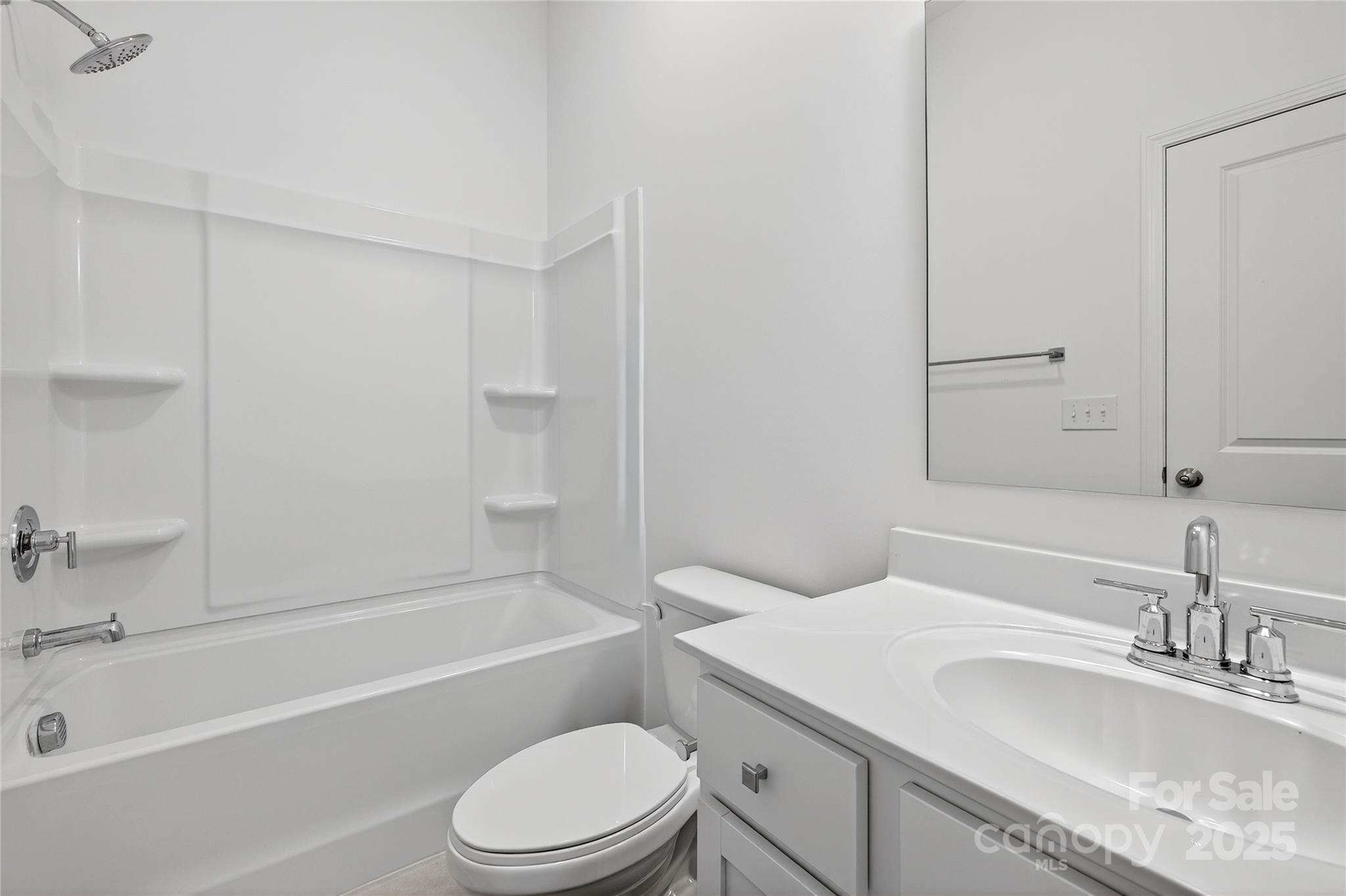 10315 Lakeshore Drive, Unit 89 Lancaster, SC 29720 - Photo 32 of 43 a bathroom with a granite countertop sink toilet vanity mirror and bathtub