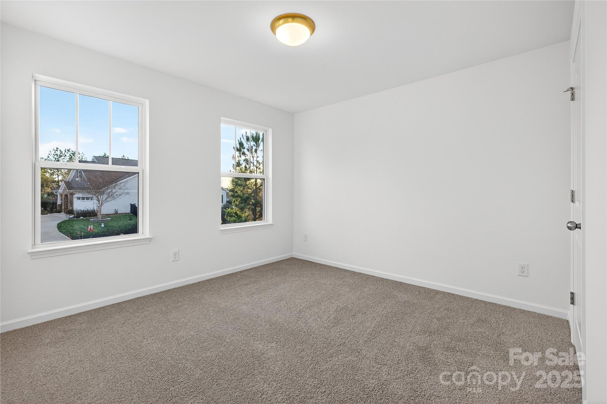 10315 Lakeshore Drive, Unit 89 Lancaster, SC 29720 - Photo 34 of 43 an empty room with windows and view of kitchen