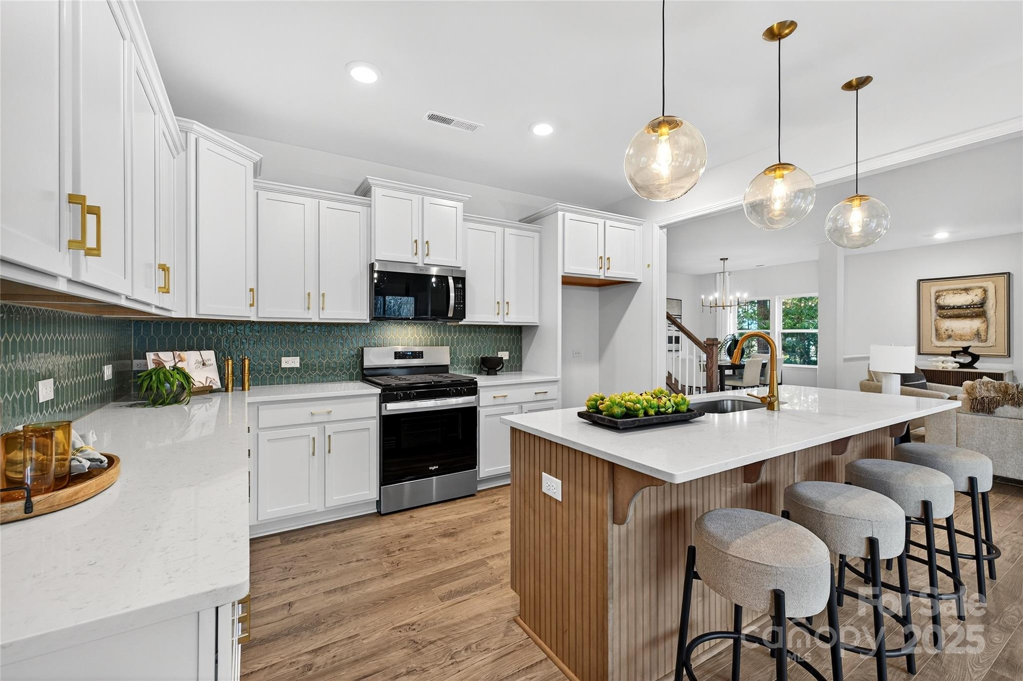 10315 Lakeshore Drive, Unit 89 Lancaster, SC 29720 - Photo 5 of 43 a kitchen with kitchen island a white table and chairs in it