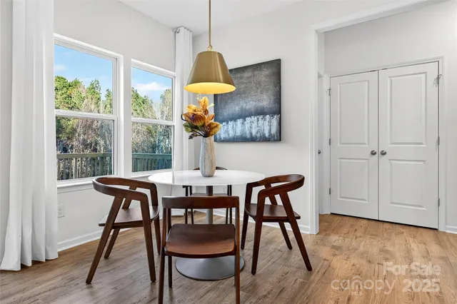 a view of a dining room with furniture window and wooden floor