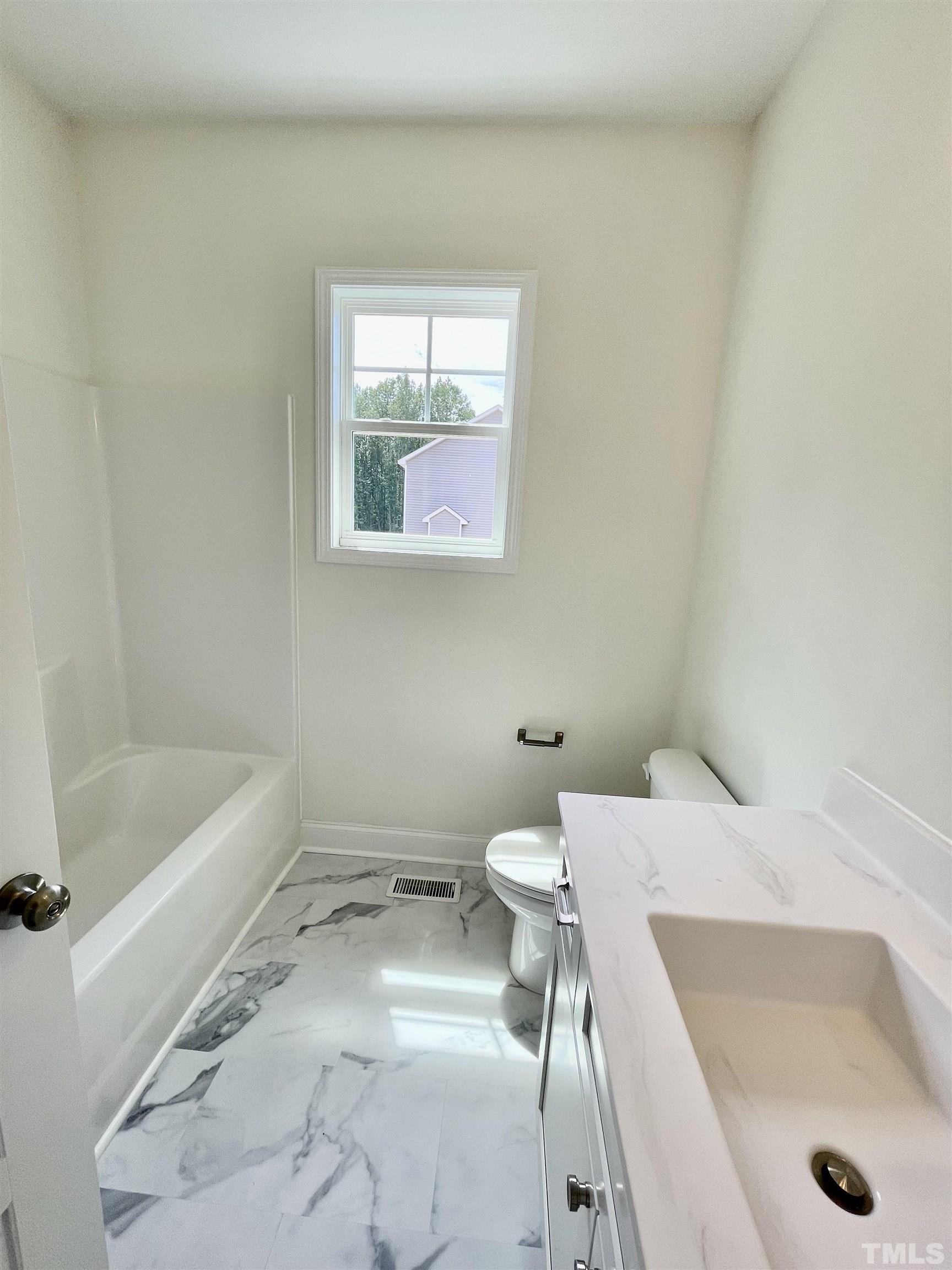 10623 West Old Spring Hope Road Spring Hope, NC 27882 - Photo 12 of 33 a bathroom with a sink and a bathtub
