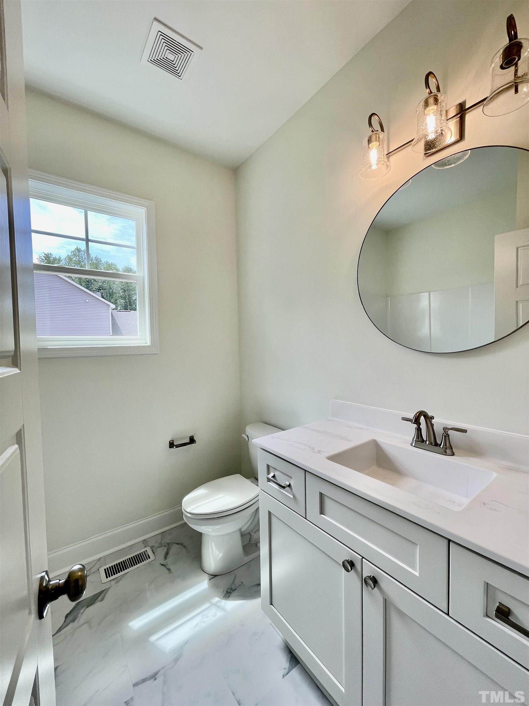 10623 West Old Spring Hope Road Spring Hope, NC 27882 - Photo 13 of 33 a bathroom with a sink and a toilet