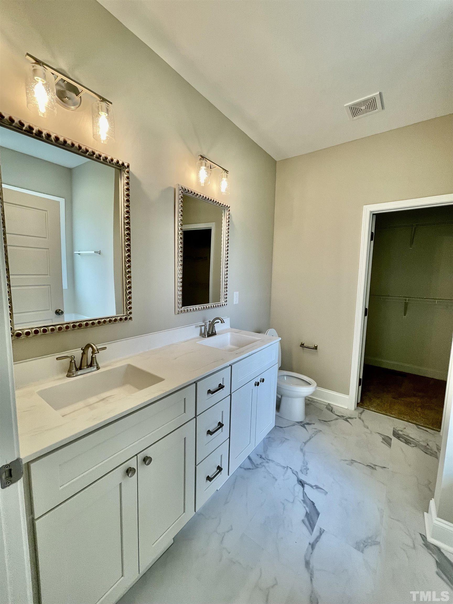 10623 West Old Spring Hope Road Spring Hope, NC 27882 - Photo 23 of 33 a spacious bathroom with a granite countertop sink mirror and a