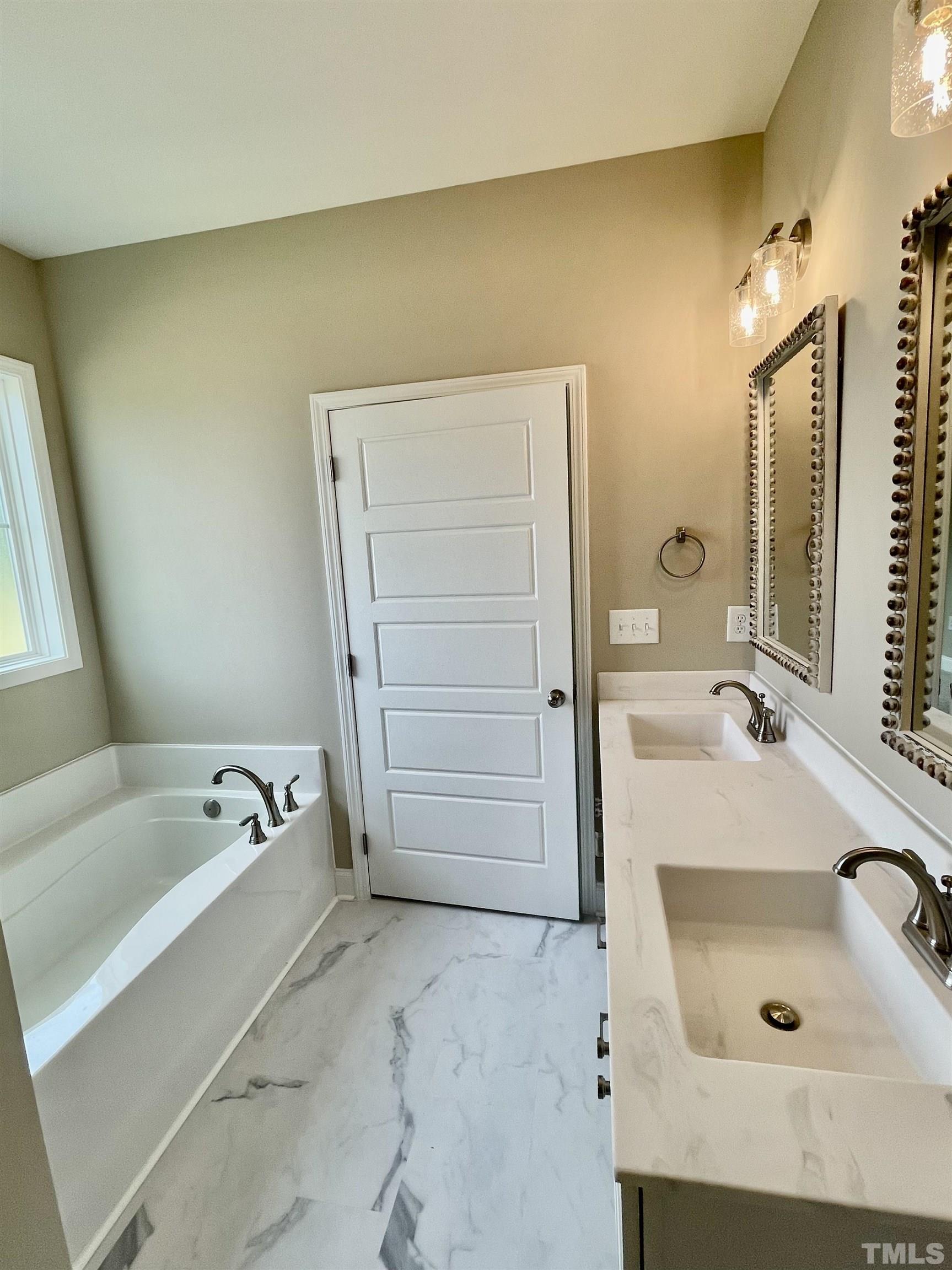 10623 West Old Spring Hope Road Spring Hope, NC 27882 - Photo 24 of 33 a bathroom with a tub sink and mirror