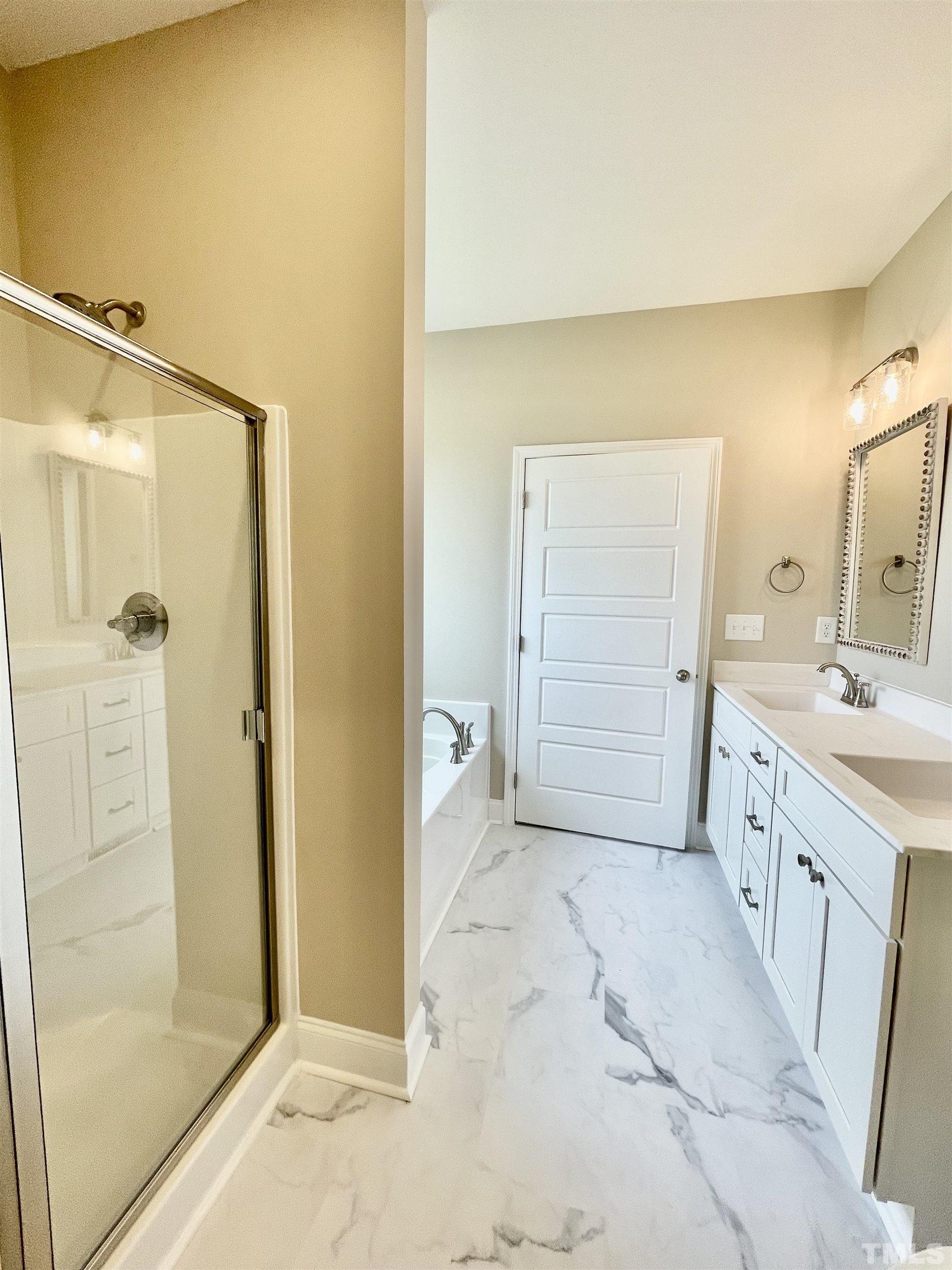 10623 West Old Spring Hope Road Spring Hope, NC 27882 - Photo 26 of 33 a bathroom with a sink a mirror and a shower