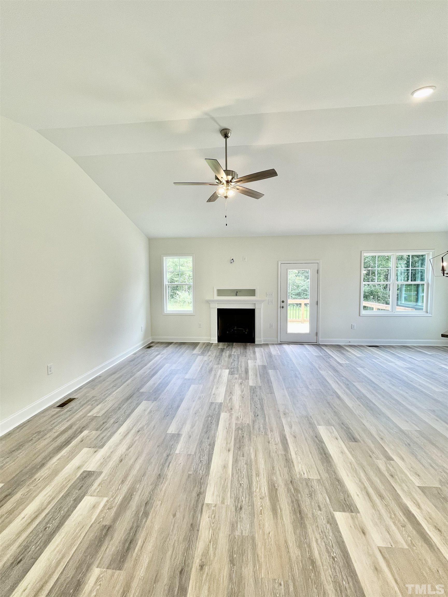10623 West Old Spring Hope Road Spring Hope, NC 27882 - Photo 4 of 33 a view of empty room with a fireplace and wooden floor