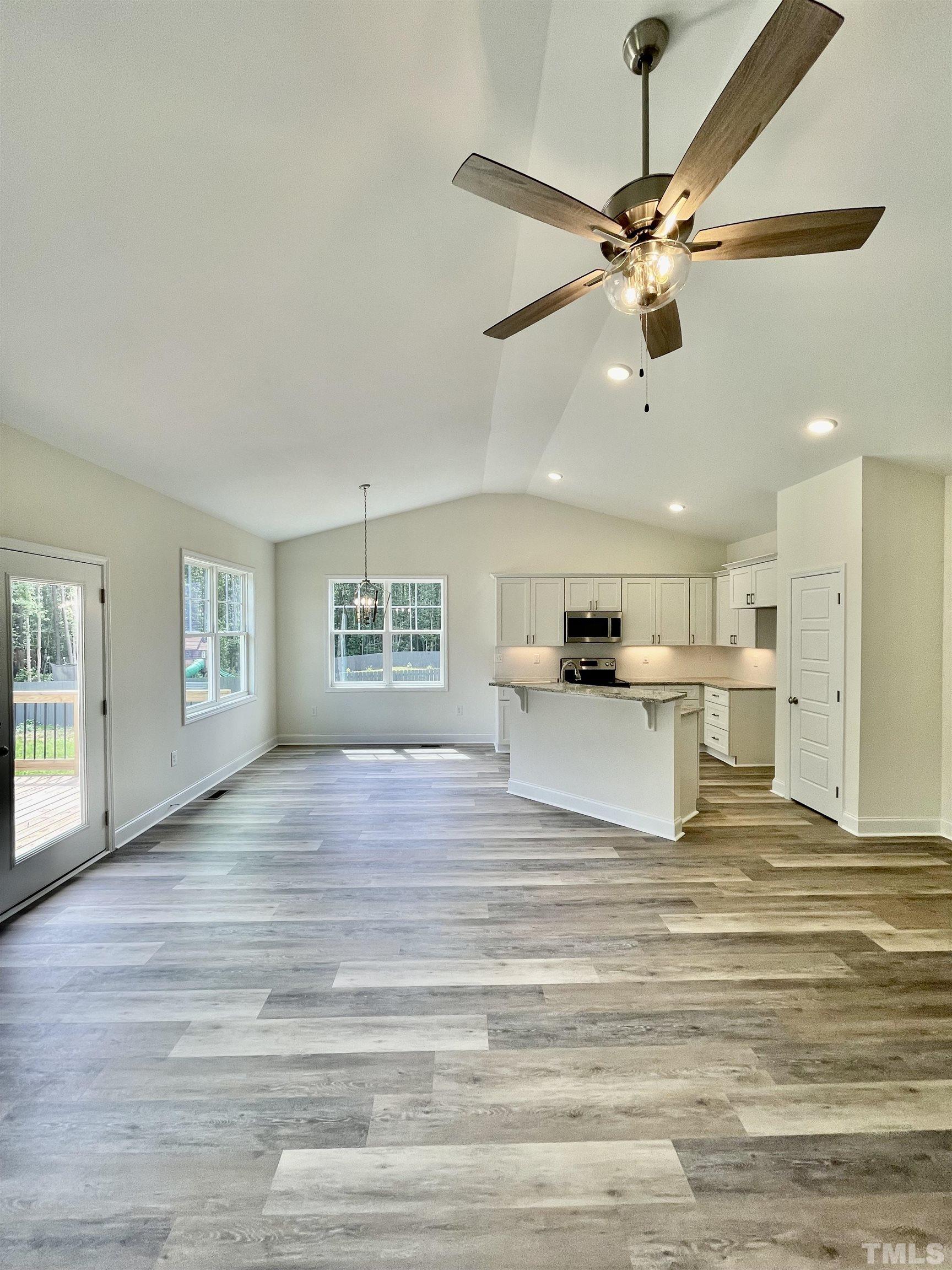 10623 West Old Spring Hope Road Spring Hope, NC 27882 - Photo 5 of 33 a view of an empty room with a window and wooden floor