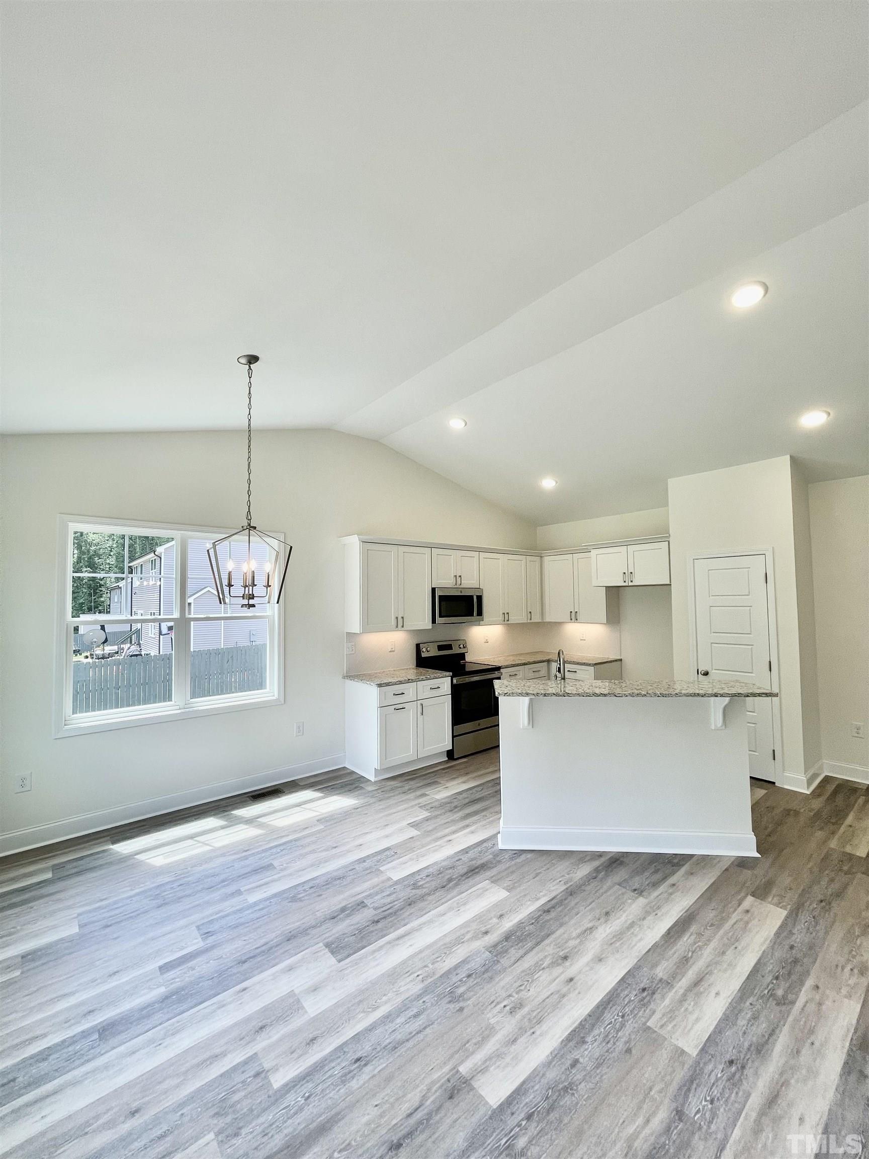10623 West Old Spring Hope Road Spring Hope, NC 27882 - Photo 6 of 33 a open kitchen with white cabinets and wooden floor