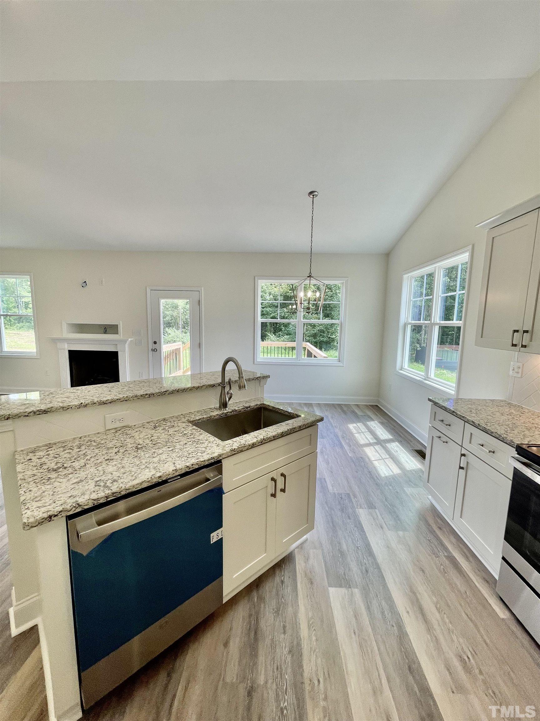 10623 West Old Spring Hope Road Spring Hope, NC 27882 - Photo 7 of 33 a kitchen with granite countertop stainless steel appliances a stove sink and microwave