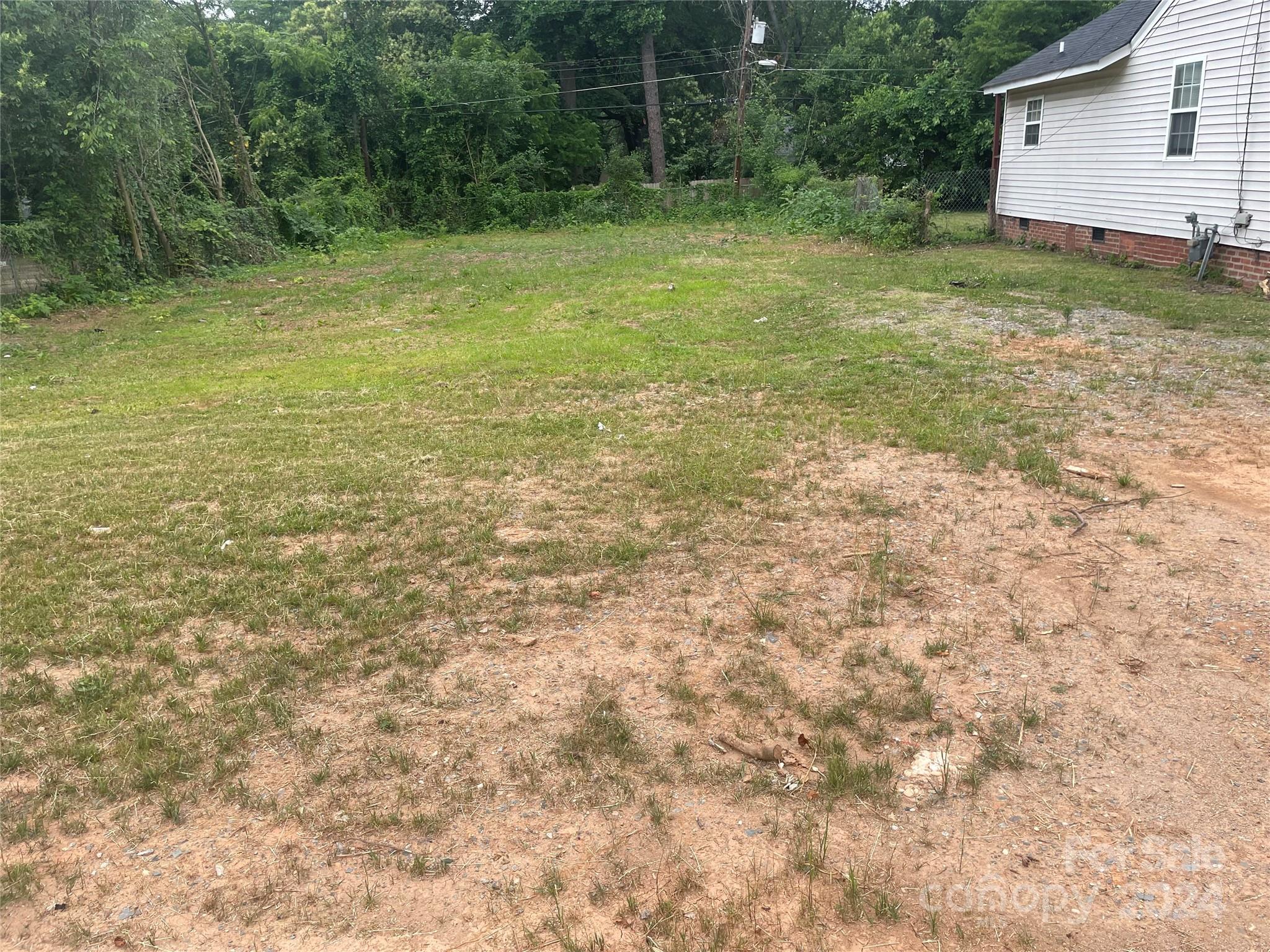 1615 Beatties Ford Road Charlotte, NC 28216 - Photo 3 of 5 a view of a backyard with large trees