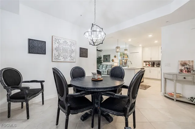 a view of a dining room with furniture and chandelier