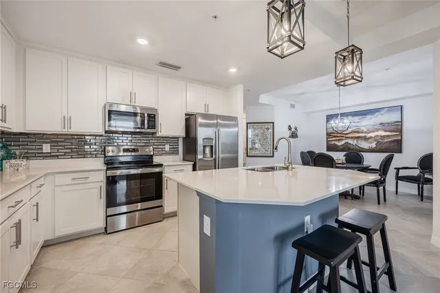 a large kitchen with a table and chairs