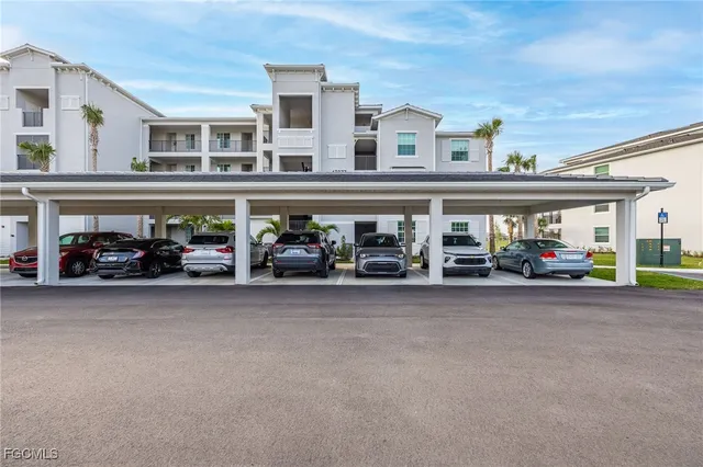 a couple of cars parked in front of a building