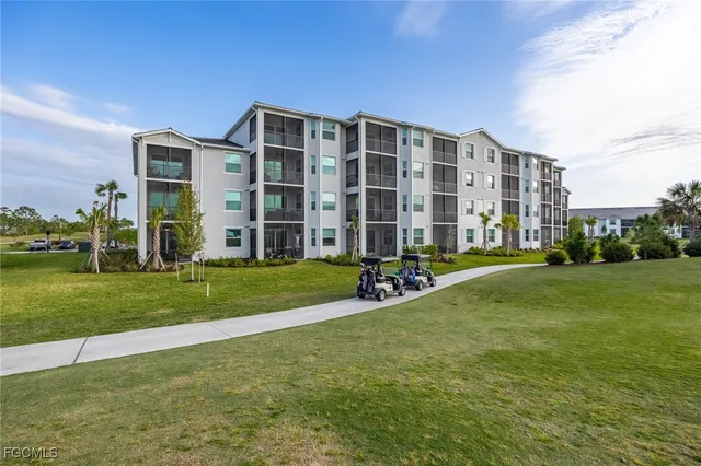 a view of a house with a big yard and large trees