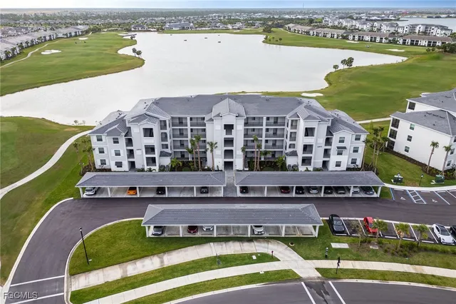 a aerial view of a house with a garden and lake view