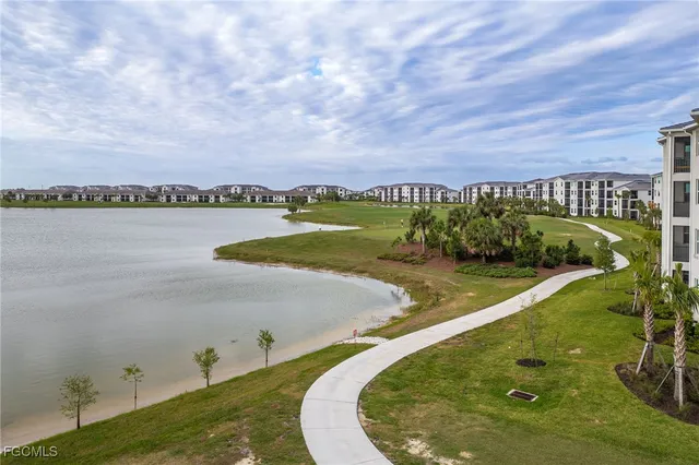 an aerial view of multiple houses with a swimming pool