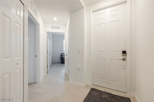 a view of a hallway with closet and bathroom