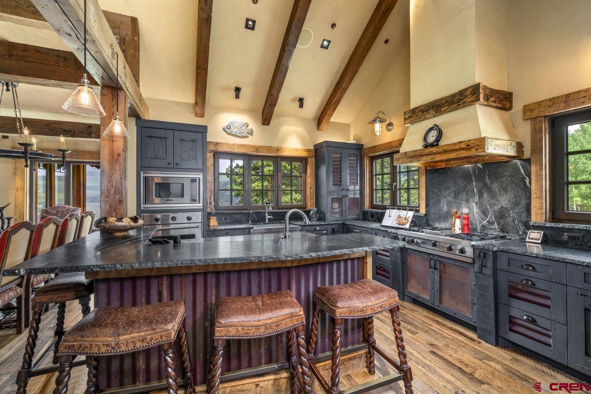 23 Gray Fox Lane Crested Butte, CO 81225 - Photo 11 of 45 a kitchen with stainless steel appliances granite countertop a stove a sink and a refrigerator