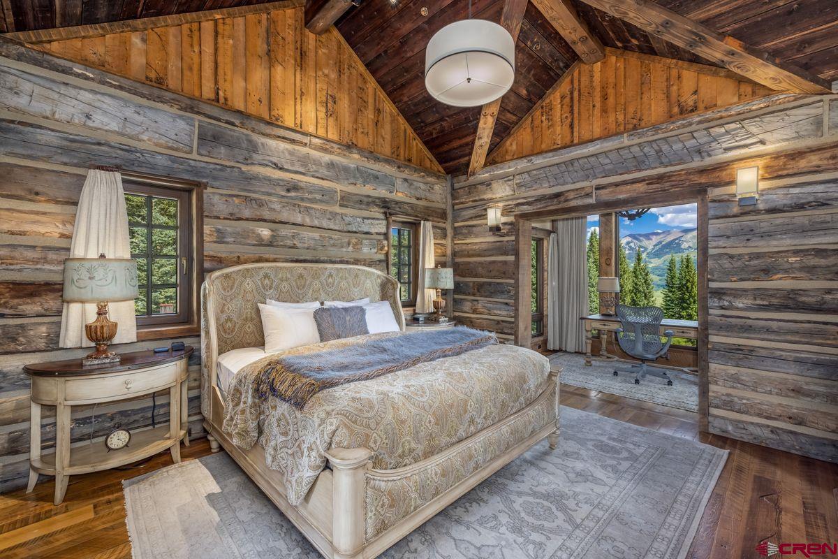 23 Gray Fox Lane Crested Butte, CO 81225 - Photo 14 of 45 a large bed sitting in a bedroom next to a window