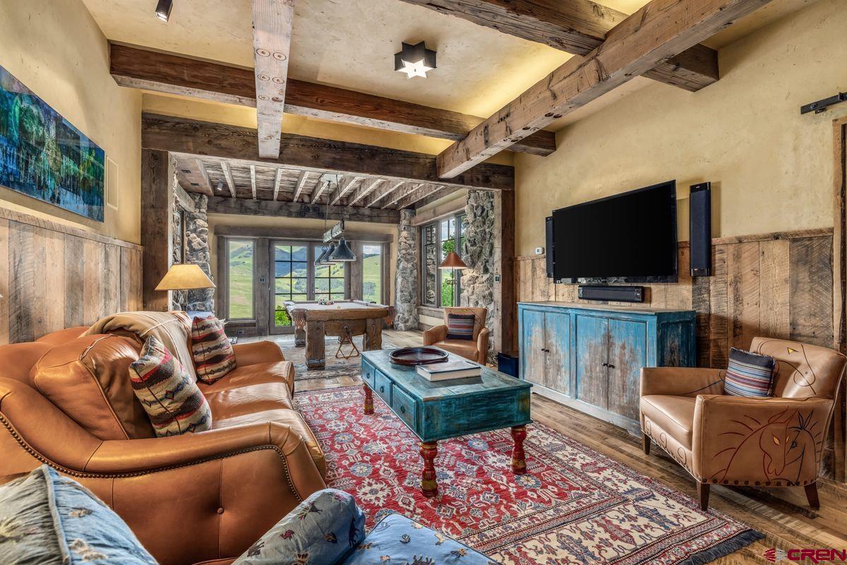 23 Gray Fox Lane Crested Butte, CO 81225 - Photo 24 of 45 a living room with furniture and a flat screen tv