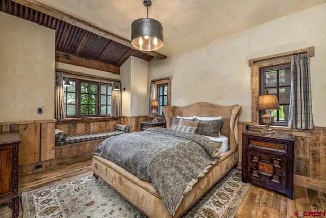 a bedroom with furniture and a rug