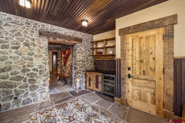 a living room with furniture kitchen view and a chandelier