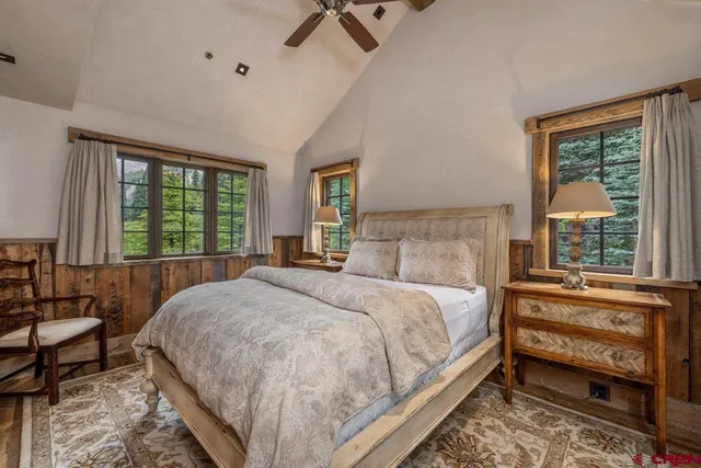 a bedroom with furniture and a large window