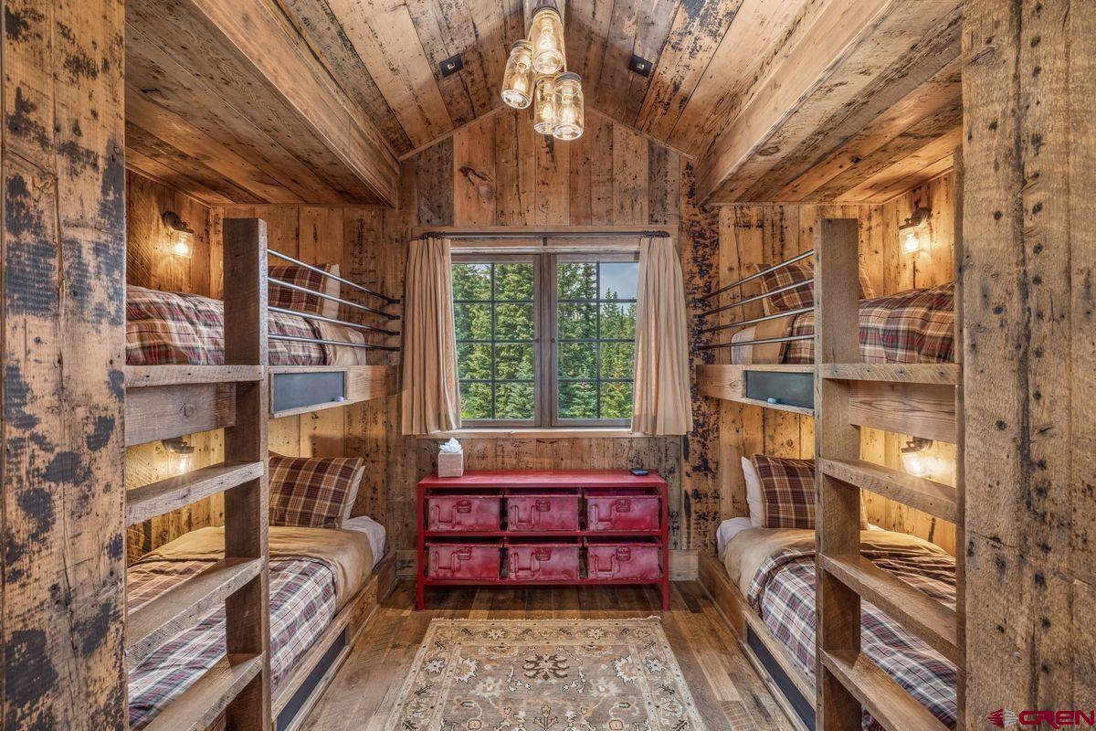 23 Gray Fox Lane Crested Butte, CO 81225 - Photo 40 of 45 a bedroom with furniture and a large window