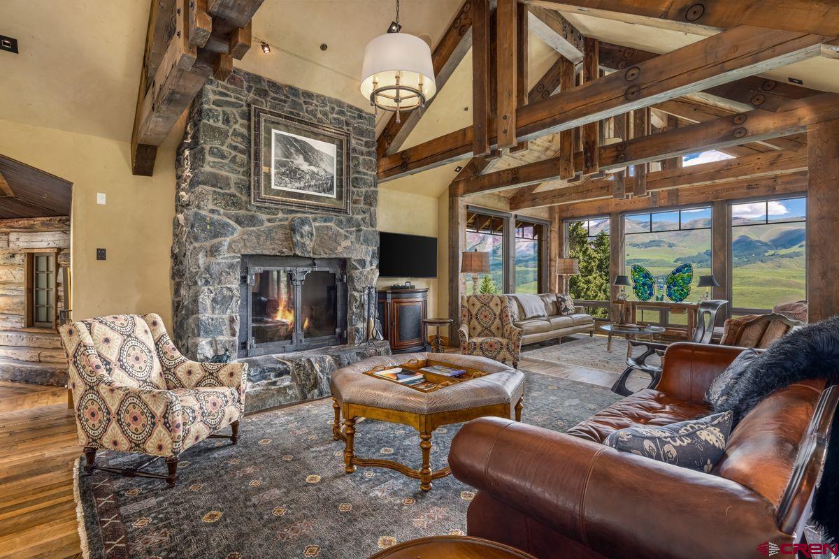 23 Gray Fox Lane Crested Butte, CO 81225 - Photo 7 of 45 a living room with furniture fireplace and a large window