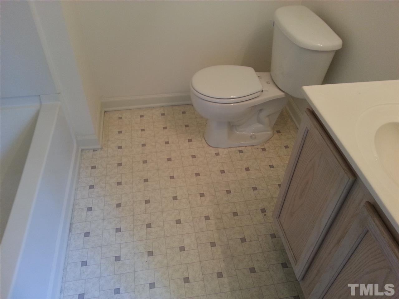 1305 Kent Road, Unit 102 Raleigh, NC 27606 - Photo 14 of 18 a bathroom with a toilet and a shower