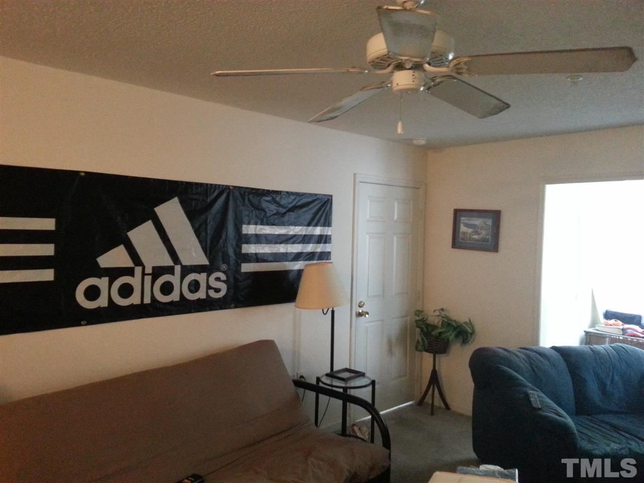 1305 Kent Road, Unit 102 Raleigh, NC 27606 - Photo 4 of 18 a living room with furniture and a ceiling fan