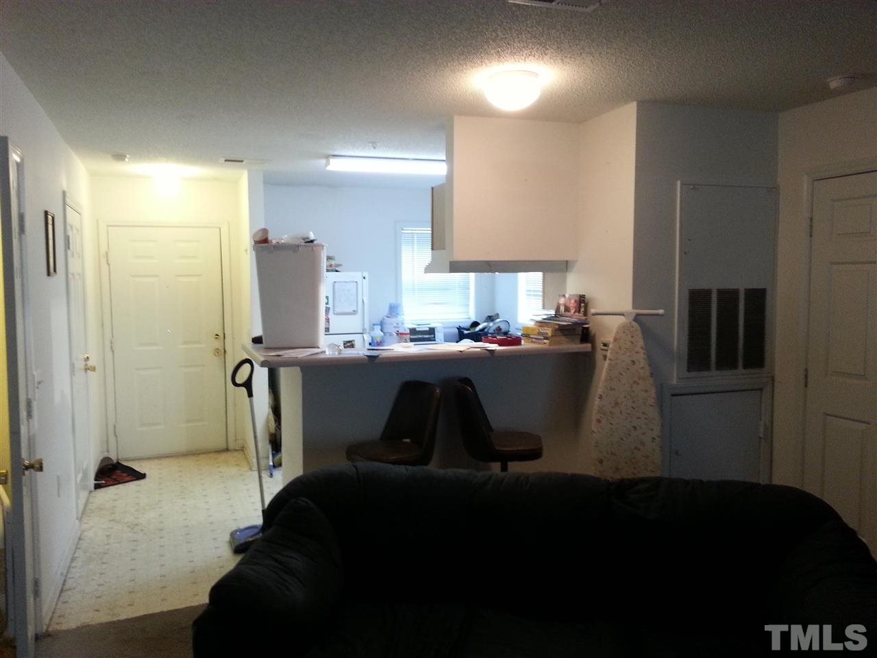 1305 Kent Road, Unit 102 Raleigh, NC 27606 - Photo 5 of 18 a kitchen with a refrigerator and a sink