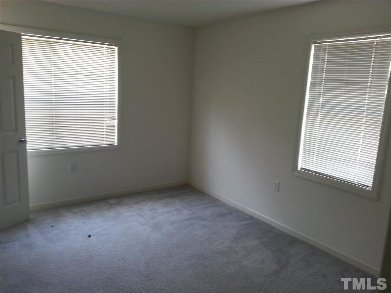 1305 Kent Road, Unit 102 Raleigh, NC 27606 - Photo 8 of 18 an empty room with a window